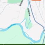 Map indicating the discharge location near Meridian St along the Green River, with the Deerfield River nearby; bottom banner reads 'Sanitary Sewer Overflow Alert' May 17, 2026 (City of Greenfield).