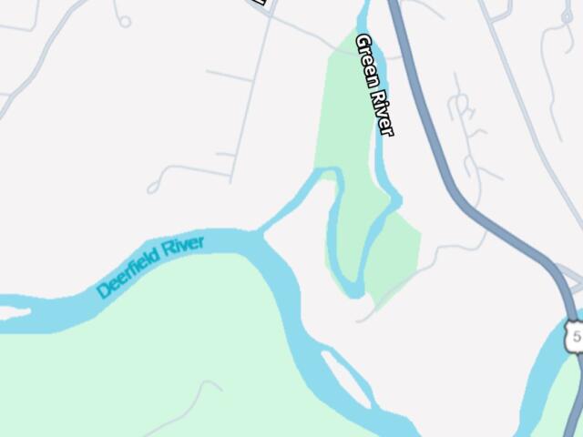 Map indicating the discharge location near Meridian St along the Green River, with the Deerfield River nearby; bottom banner reads 'Sanitary Sewer Overflow Alert' May 17, 2026 (City of Greenfield).